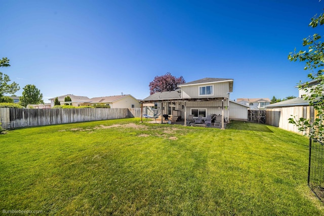 1612 E Sharpsburg Ave, Spokane, WA 99217 - back of property featuring a fenced backyard and a patio area