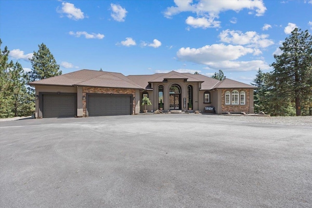 7105 S Saddle Ridge Ln, Spokane Valley, WA 99016 - view of front of house featuring an attached garage and asphalt driveway