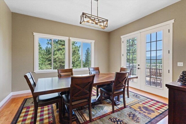 7105 S Saddle Ridge Ln, Spokane Valley, WA 99016 - dining area featuring light wood-type flooring and a chandelier