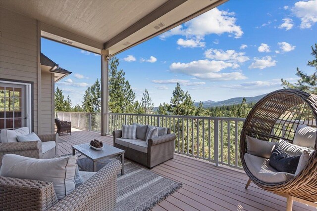 7105 S Saddle Ridge Ln, Spokane Valley, WA 99016 - wooden deck featuring an outdoor living space and a mountain view