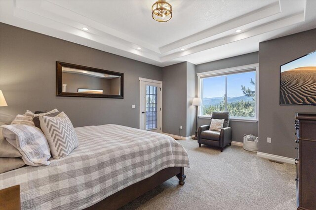 7105 S Saddle Ridge Ln, Spokane Valley, WA 99016 - carpeted bedroom featuring a raised ceiling, multiple windows, recessed lighting, and access to outside