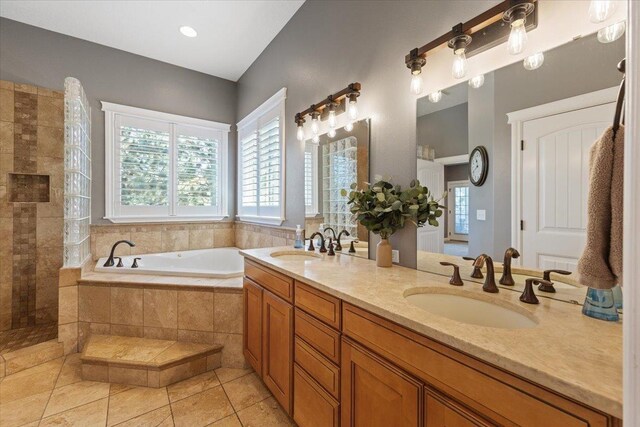 7105 S Saddle Ridge Ln, Spokane Valley, WA 99016 - bathroom featuring healthy amount of natural light, a bath, double vanity, and tile patterned floors