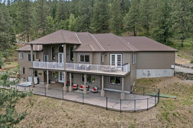 7105 S Saddle Ridge Ln, Spokane Valley, WA 99016 - rear view of house featuring a patio, french doors, a view of trees, and a fenced backyard