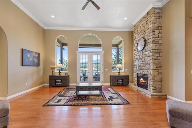 7105 S Saddle Ridge Ln, Spokane Valley, WA 99016 - entrance foyer featuring ceiling fan, ornamental molding, a stone fireplace, wood finished floors, and french doors