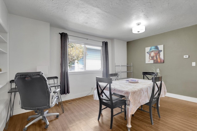 2505 W Mallon Ave, Spokane, WA 99201 - dining room featuring wood finished floors, a textured ceiling, and a desk