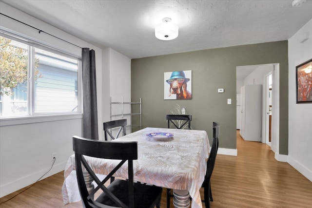 2505 W Mallon Ave, Spokane, WA 99201 - dining area featuring light wood-style flooring and a textured ceiling