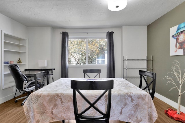 2505 W Mallon Ave, Spokane, WA 99201 - bedroom featuring a textured ceiling, wood finished floors, and a desk