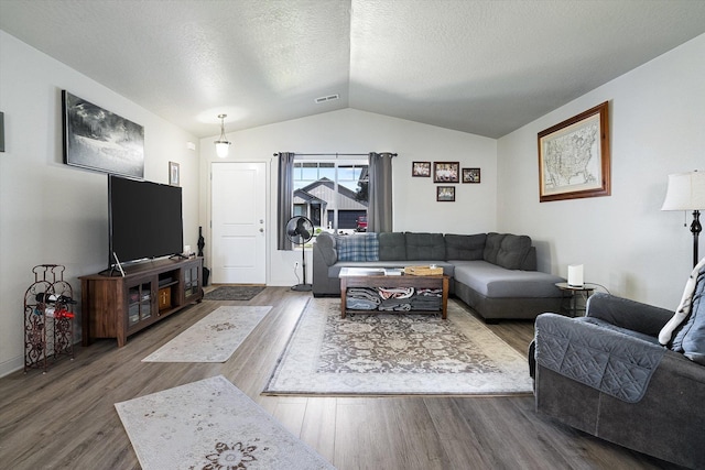 124 S Lone Tree Ave, Spokane Valley, WA 99016 - living area with wood finished floors, lofted ceiling, and a textured ceiling
