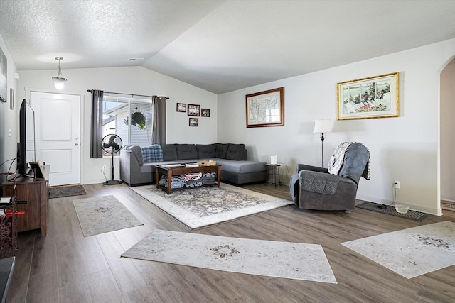 124 S Lone Tree Ave, Spokane Valley, WA 99016 - living room with wood finished floors, arched walkways, and vaulted ceiling