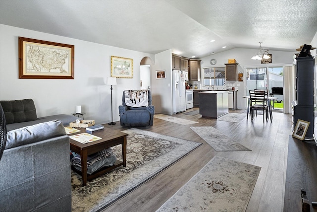 124 S Lone Tree Ave, Spokane Valley, WA 99016 - living room with lofted ceiling, a chandelier, and wood finished floors