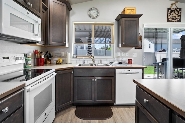 124 S Lone Tree Ave, Spokane Valley, WA 99016 - kitchen with white appliances, light wood-style flooring, plenty of natural light, and dark brown cabinets