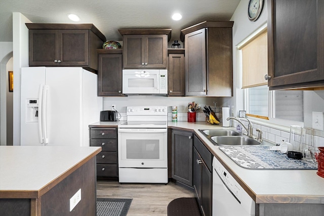 124 S Lone Tree Ave, Spokane Valley, WA 99016 - kitchen featuring white appliances, dark brown cabinets, light wood-type flooring, light countertops, and recessed lighting