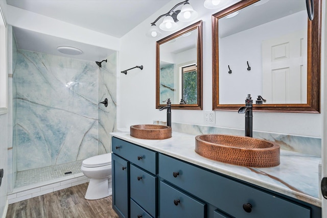 317 E Eaton Ave, Spokane, WA 99218 - bathroom with a marble finish shower, vanity, and wood finished floors