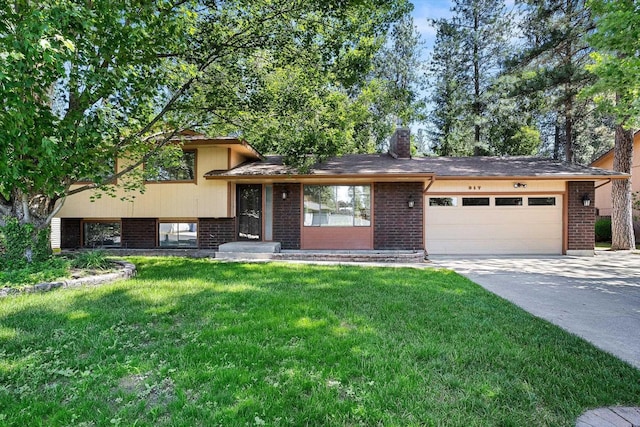 317 E Eaton Ave, Spokane, WA 99218 - tri-level home featuring a garage, brick siding, a front yard, and concrete driveway
