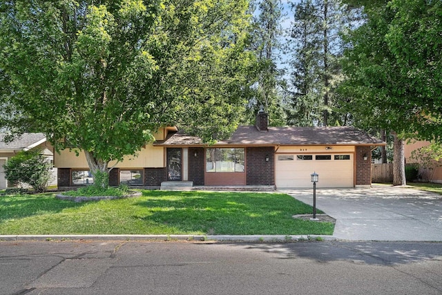317 E Eaton Ave, Spokane, WA 99218 - split level home with an attached garage, concrete driveway, brick siding, and a chimney