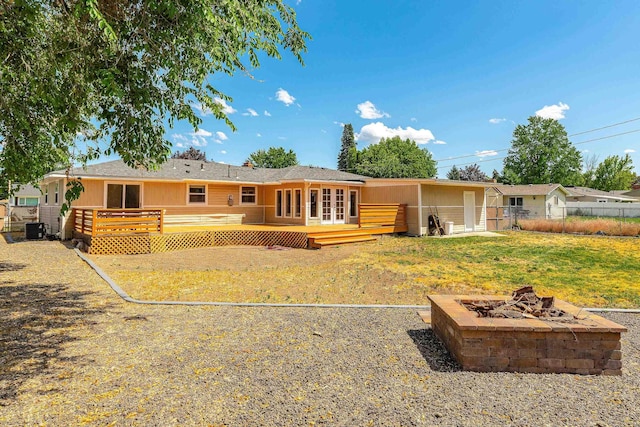 1718 S Bolivar Rd, Spokane Valley, WA 99037 - rear view of house with a wooden deck, a fire pit, and french doors