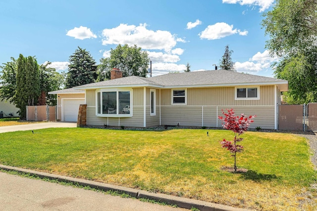 1718 S Bolivar Rd, Spokane Valley, WA 99037 - ranch-style house with concrete driveway, a garage, a chimney, and roof with shingles