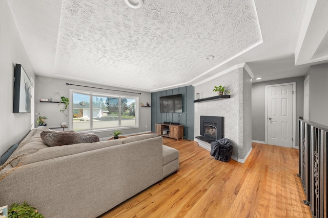 1718 S Bolivar Rd, Spokane Valley, WA 99037 - living area featuring a textured ceiling, light wood-style floors, and a brick fireplace