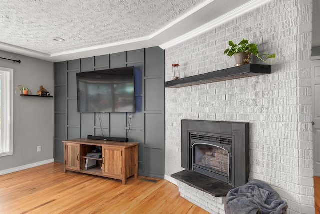 1718 S Bolivar Rd, Spokane Valley, WA 99037 - living area with light wood-style floors and a glass covered fireplace
