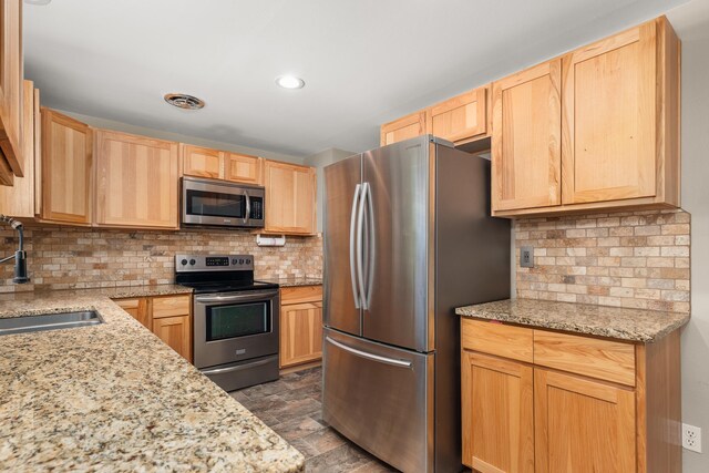 1718 S Bolivar Rd, Spokane Valley, WA 99037 - kitchen featuring stainless steel appliances, light brown cabinetry, backsplash, light stone counters, and recessed lighting