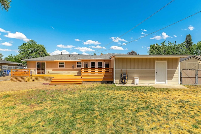 1718 S Bolivar Rd, Spokane Valley, WA 99037 - rear view of house with a storage shed, a lawn, and a wooden deck