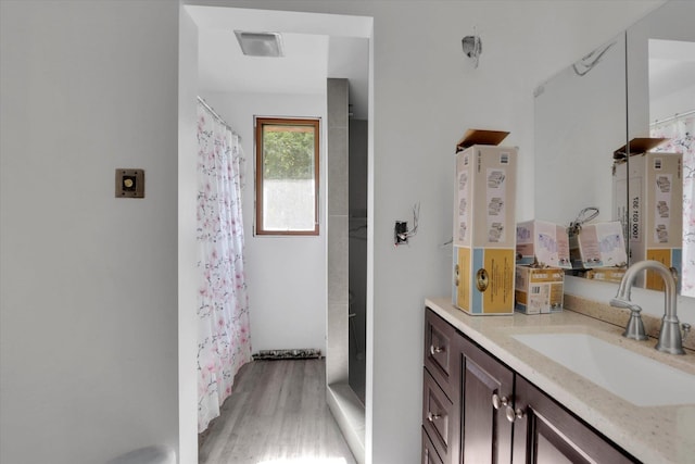 2411 E Girard Pl, Spokane, WA 99223 - full bath with vanity, wood finished floors, and curtained shower