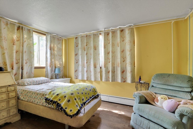 2411 E Girard Pl, Spokane, WA 99223 - bedroom with baseboard heating and wood finished floors