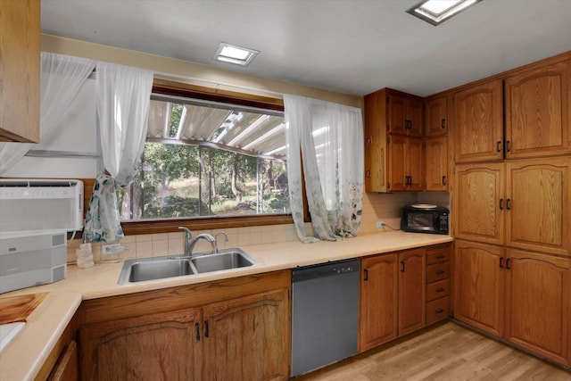 2411 E Girard Pl, Spokane, WA 99223 - kitchen with dishwasher, black microwave, brown cabinets, and tasteful backsplash