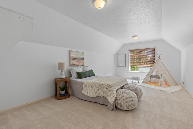 9909 N Ivanhoe Rd, Spokane, WA 99218 - bedroom with carpet flooring, vaulted ceiling, and a textured ceiling