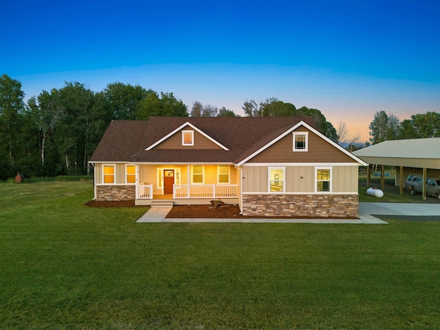 37818 N Grove Rd, Deer Park, WA 99006 - view of front of house with stone siding, a porch, a front lawn, board and batten siding, and roof with shingles