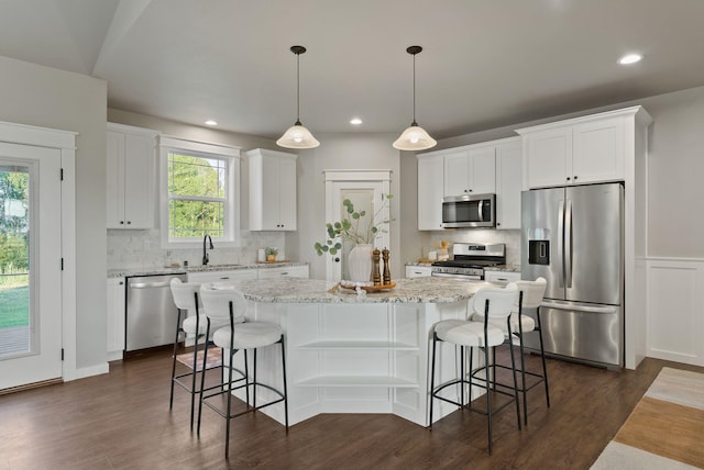 37818 N Grove Rd, Deer Park, WA 99006 - kitchen featuring appliances with stainless steel finishes, dark wood-style floors, a center island, white cabinets, and recessed lighting