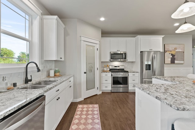 37818 N Grove Rd, Deer Park, WA 99006 - kitchen with stainless steel appliances, decorative backsplash, white cabinetry, dark wood finished floors, and recessed lighting