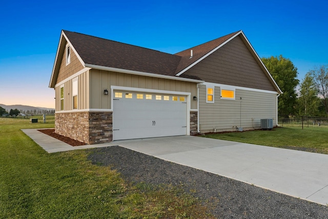 37818 N Grove Rd, Deer Park, WA 99006 - view of property exterior featuring board and batten siding, an attached garage, stone siding, driveway, and roof with shingles