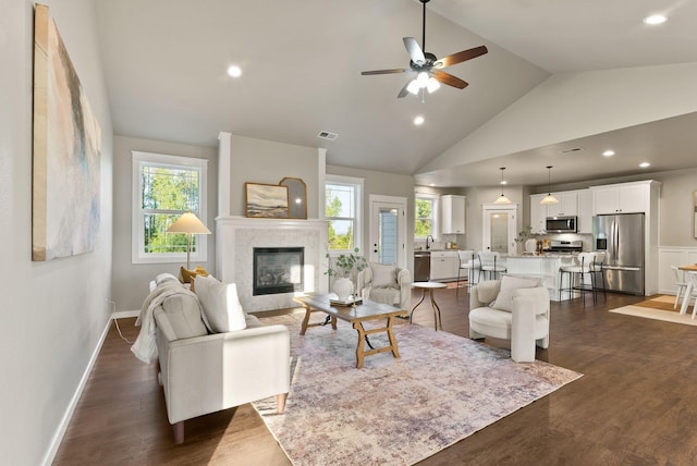 37818 N Grove Rd, Deer Park, WA 99006 - living room with a glass covered fireplace, ceiling fan, dark wood-type flooring, recessed lighting, and high vaulted ceiling