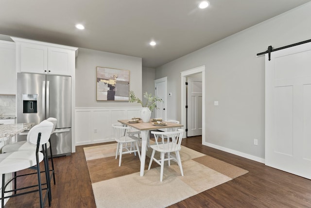 37818 N Grove Rd, Deer Park, WA 99006 - dining space featuring a barn door, dark wood finished floors, recessed lighting, and wainscoting