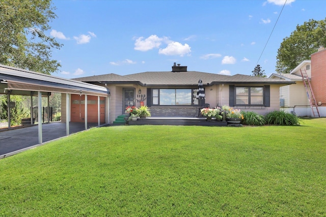 1102 S Buena Vista Dr, Spokane, WA 99224 - ranch-style house with an attached garage, asphalt driveway, a front lawn, a chimney, and a carport
