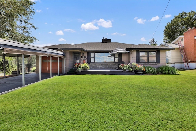 1102 S Buena Vista Dr, Spokane, WA 99224 - view of front of house with an attached garage, driveway, a front lawn, a carport, and a chimney