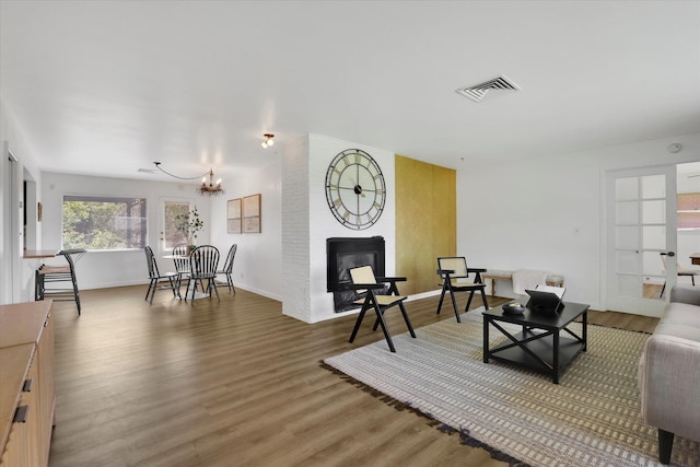 1102 S Buena Vista Dr, Spokane, WA 99224 - living room featuring a chandelier and light wood-style flooring