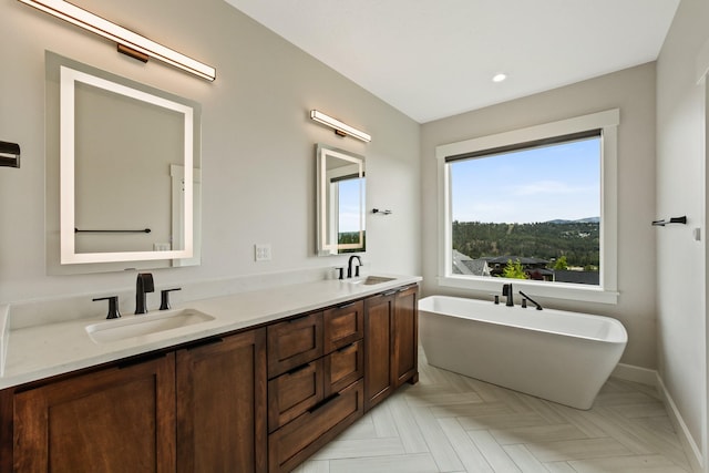 5206 S Willamette St, Spokane, WA 99223 - bathroom featuring double vanity, a freestanding tub, and recessed lighting