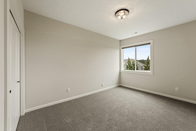 5206 S Willamette St, Spokane, WA 99223 - unfurnished room featuring baseboards and dark colored carpet