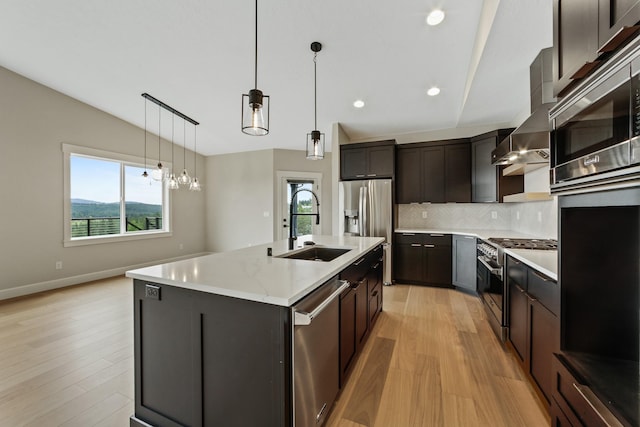 5206 S Willamette St, Spokane, WA 99223 - kitchen featuring stainless steel appliances, light wood-style floors, backsplash, an island with sink, and lofted ceiling