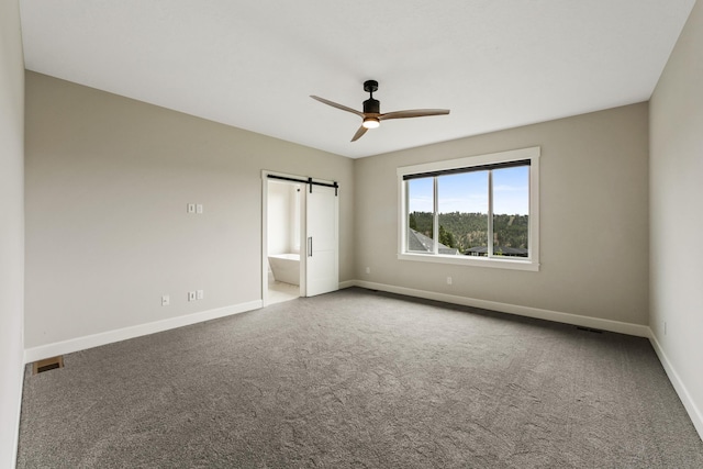 5206 S Willamette St, Spokane, WA 99223 - unfurnished bedroom with carpet floors, a barn door, connected bathroom, and ceiling fan