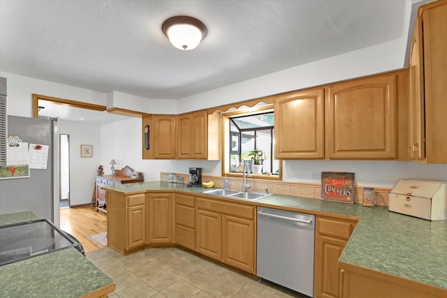 1310 N Woodruff Rd, Spokane Valley, WA 99206 - kitchen with stainless steel appliances, a peninsula, light tile patterned floors, and dark countertops