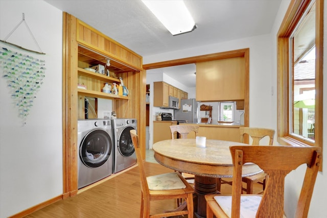 1310 N Woodruff Rd, Spokane Valley, WA 99206 - dining area featuring washing machine and clothes dryer and light wood finished floors