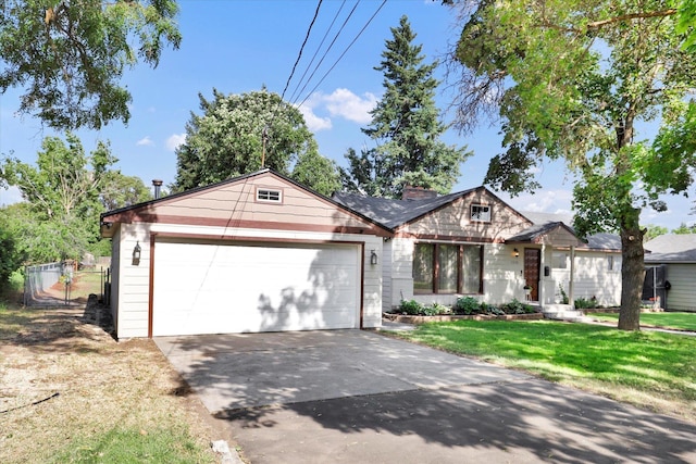1310 N Woodruff Rd, Spokane Valley, WA 99206 - ranch-style home with an attached garage, driveway, and a chimney