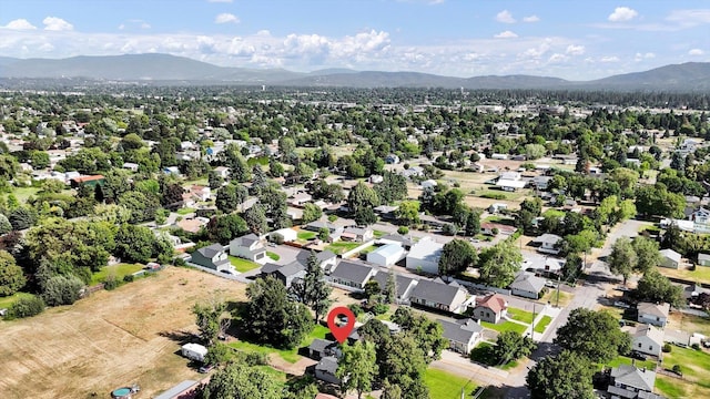 1310 N Woodruff Rd, Spokane Valley, WA 99206 - aerial view of property's location featuring a mountainous background and nearby suburban area