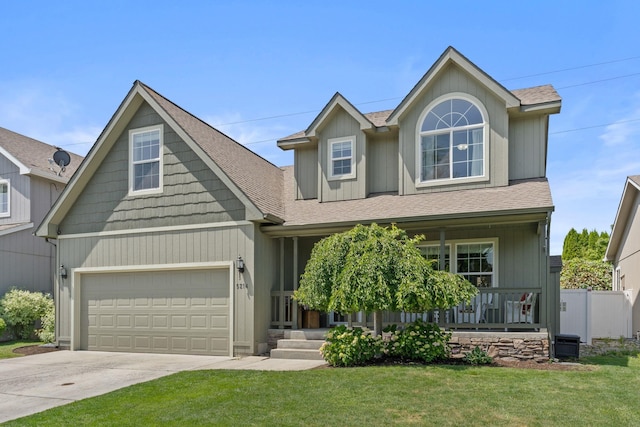 5214 S Myrtle Ln, Spokane, WA 99223 - view of front facade with covered porch, a front lawn, roof with shingles, concrete driveway, and a garage