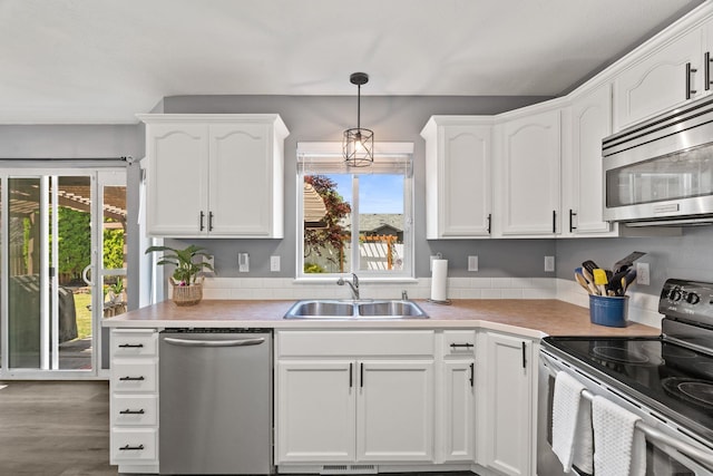 5214 S Myrtle Ln, Spokane, WA 99223 - kitchen with appliances with stainless steel finishes, white cabinetry, and light countertops