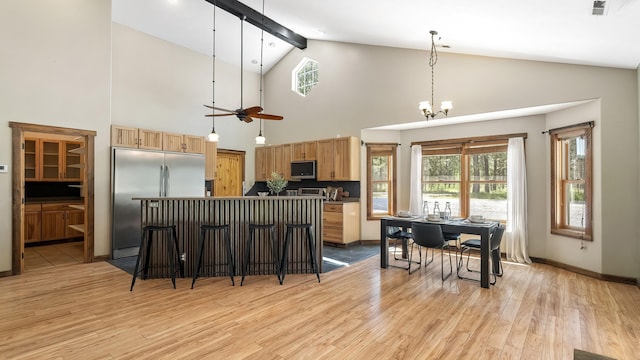 38415 N Hatch Rd, Deer Park, WA 99006 - kitchen with appliances with stainless steel finishes, a center island, light wood-style floors, high vaulted ceiling, and pendant lighting