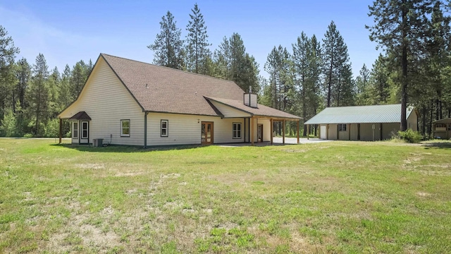 38415 N Hatch Rd, Deer Park, WA 99006 - rear view of house featuring a yard, a chimney, and a patio